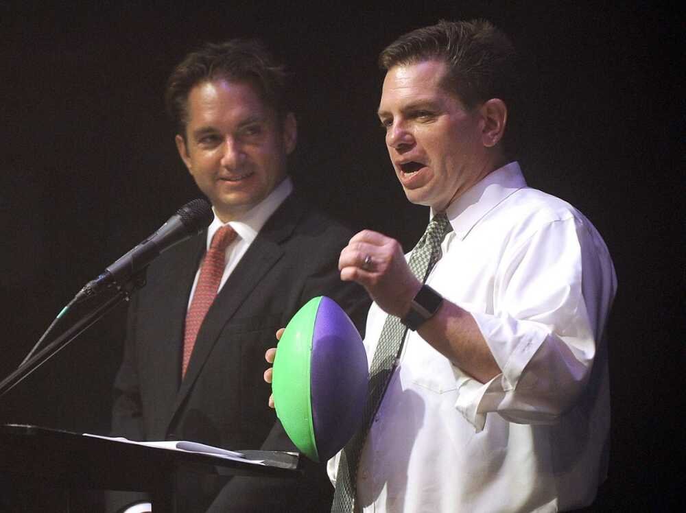 Jon K. Rust observes as brother Rex Rust gets ready to toss a football into the balcony at Southeast Missouri State University’s River Campus in Cape Girardeau during the 2018 Semoball Awards. Rex’s throw was an annual tradition at the high school sports event. (Photo credit: Southeast Missourian)